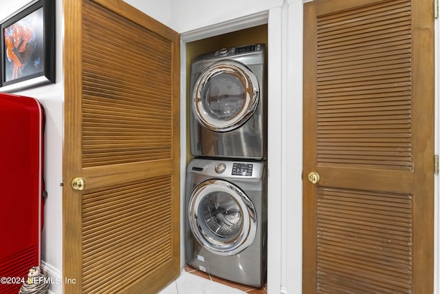 clothes washing area with stacked washer and clothes dryer