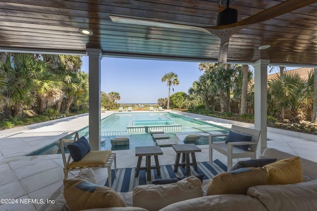 view of swimming pool featuring a patio area and ceiling fan