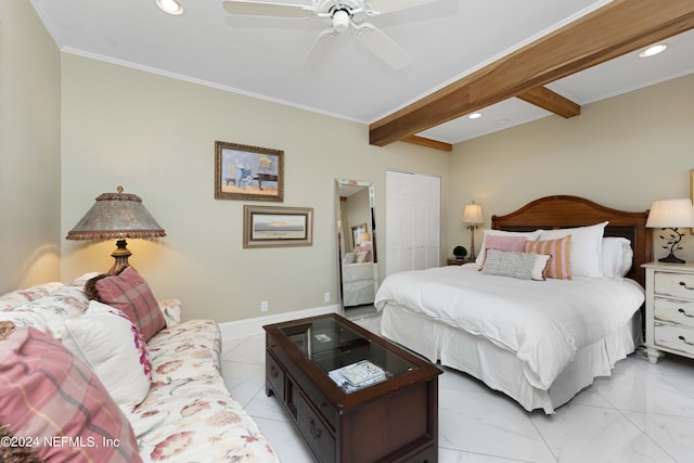 bedroom with beamed ceiling, ceiling fan, and a closet