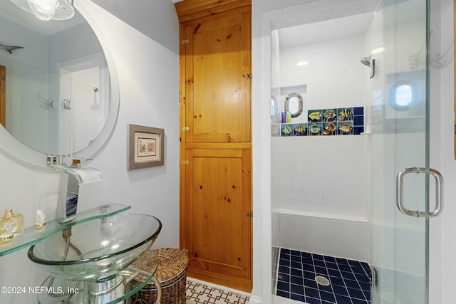 bathroom with a shower with shower door