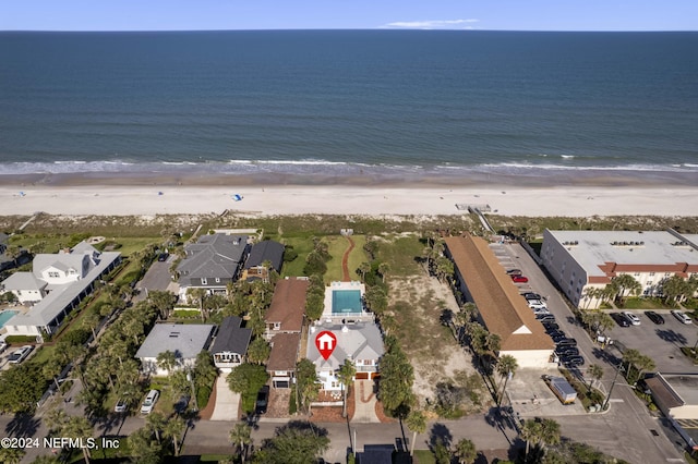 drone / aerial view featuring a water view and a view of the beach