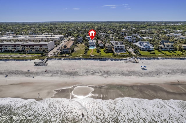 birds eye view of property featuring a water view and a beach view