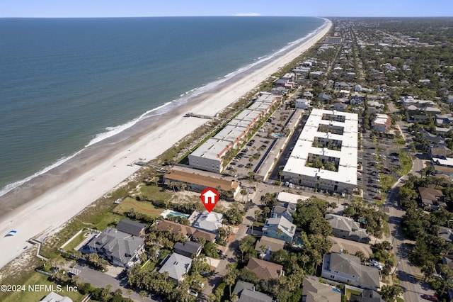 bird's eye view with a water view and a beach view