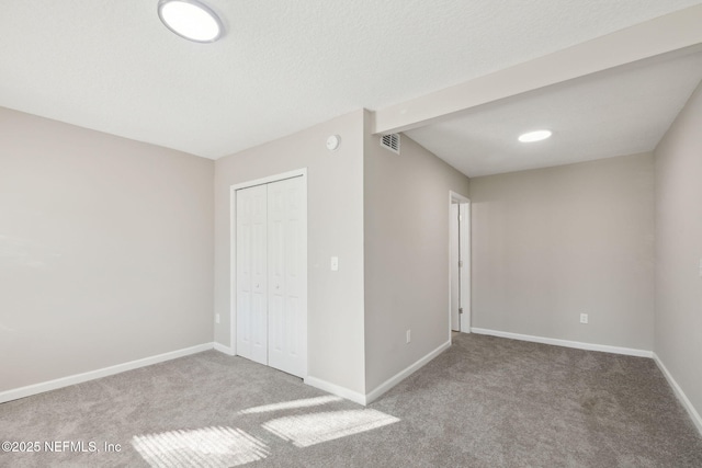 unfurnished bedroom featuring carpet flooring and a closet