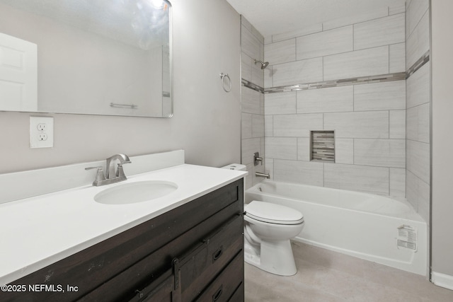 full bathroom with vanity, tiled shower / bath combo, and toilet