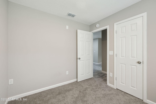 unfurnished bedroom featuring light colored carpet