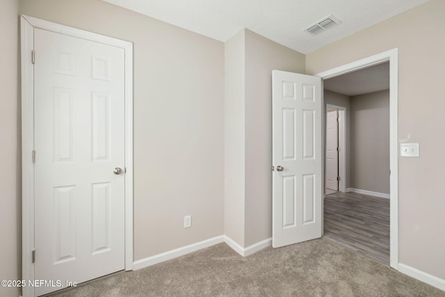 unfurnished bedroom with light carpet