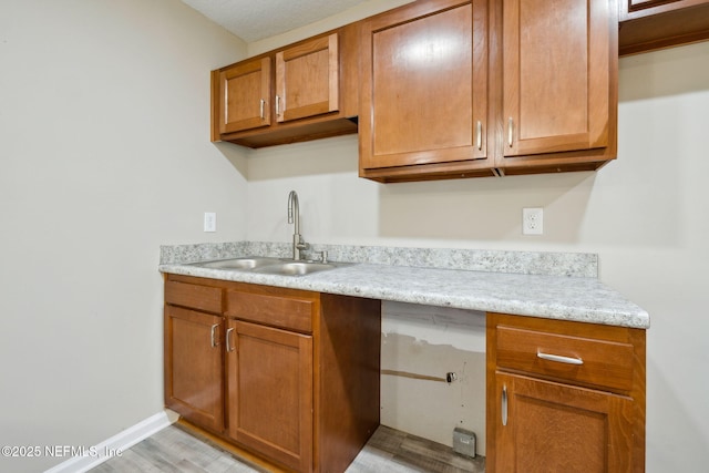 kitchen with sink and light hardwood / wood-style flooring