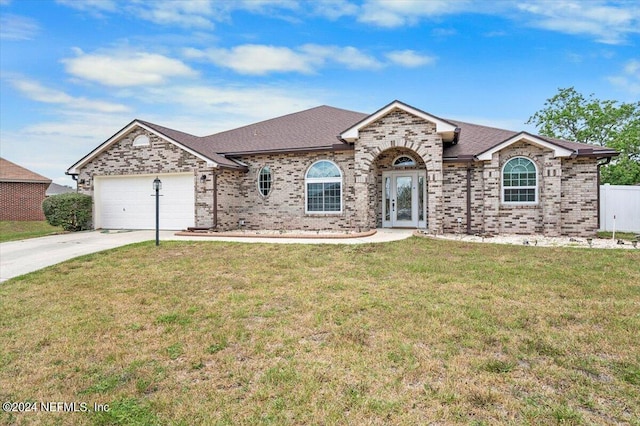 ranch-style home featuring a garage and a front lawn