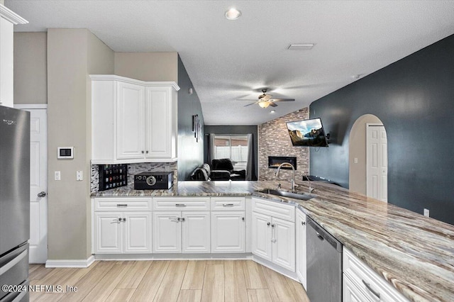 kitchen featuring white cabinetry, sink, ceiling fan, stainless steel appliances, and a textured ceiling