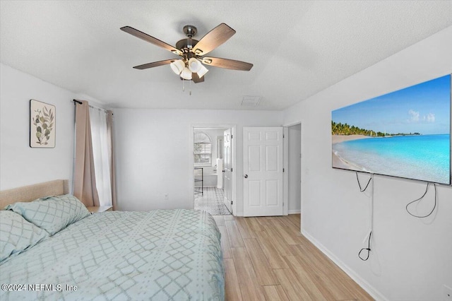 bedroom featuring ceiling fan, light hardwood / wood-style floors, and a textured ceiling