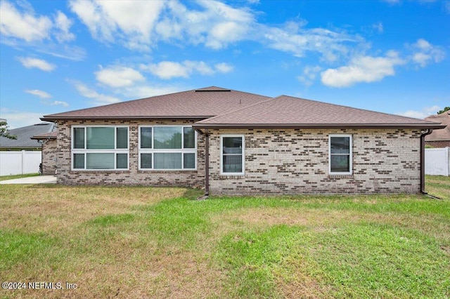 back of house with a lawn