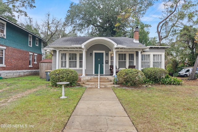 bungalow-style house featuring a front lawn