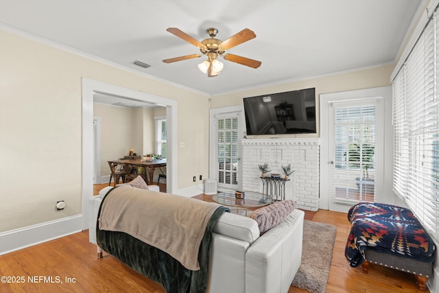 living room featuring hardwood / wood-style flooring, ceiling fan, and ornamental molding