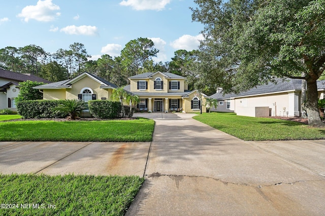 view of front of property with a porch and a front yard