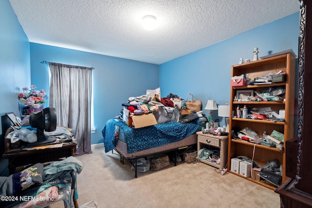 carpeted bedroom featuring a textured ceiling