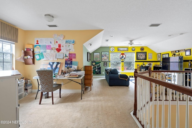 office area with ceiling fan, a textured ceiling, light carpet, and vaulted ceiling