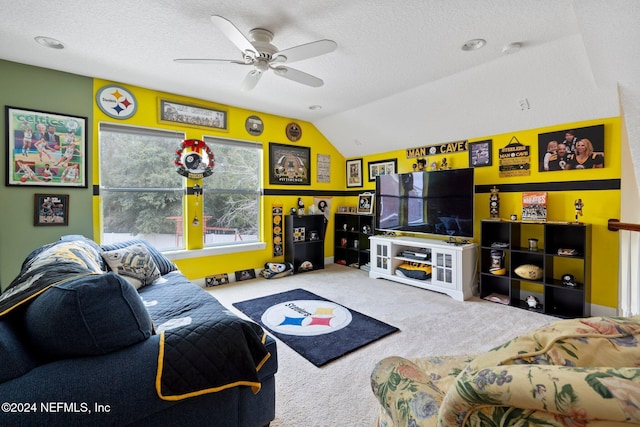 living room with a textured ceiling, ceiling fan, carpet, and vaulted ceiling