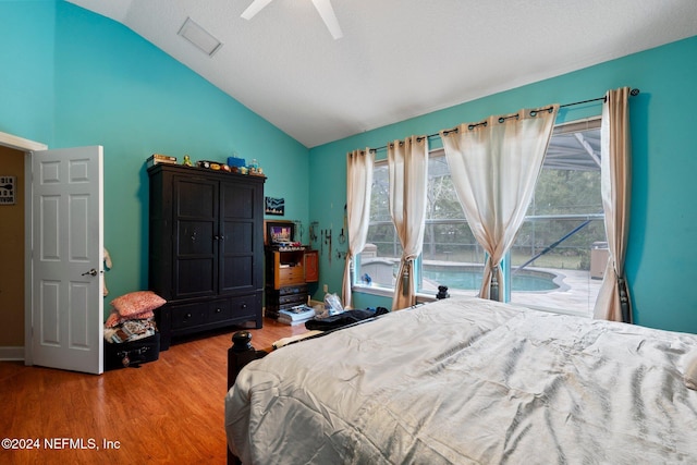 bedroom with hardwood / wood-style flooring, ceiling fan, and lofted ceiling