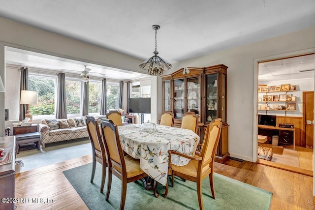 dining area featuring wood-type flooring and a chandelier