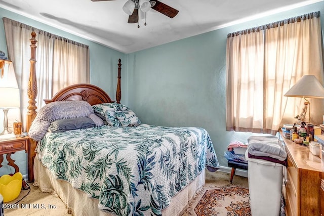 bedroom featuring multiple windows and ceiling fan