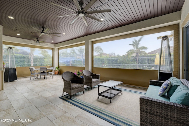 sunroom / solarium featuring wooden ceiling and ceiling fan