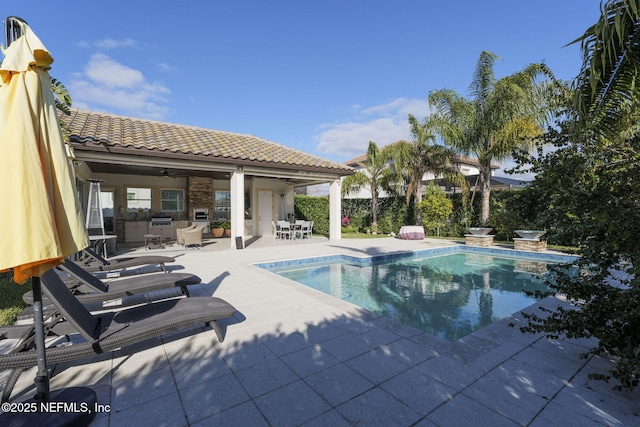 view of swimming pool with ceiling fan and a patio area