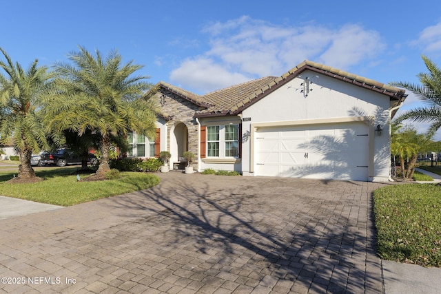 mediterranean / spanish-style house with a garage and a front lawn