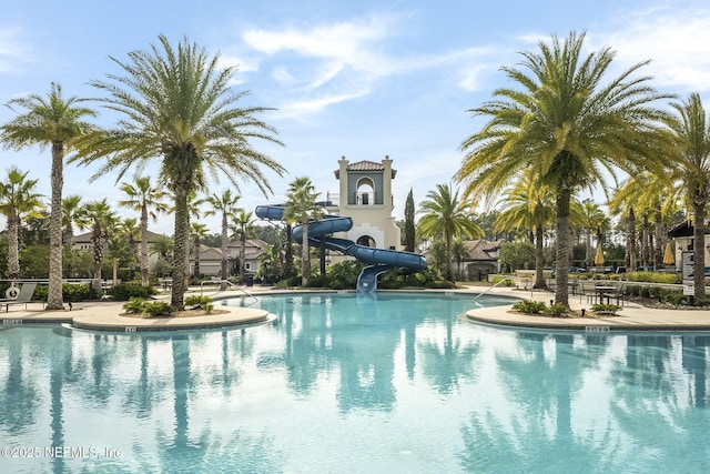 view of swimming pool with a water slide