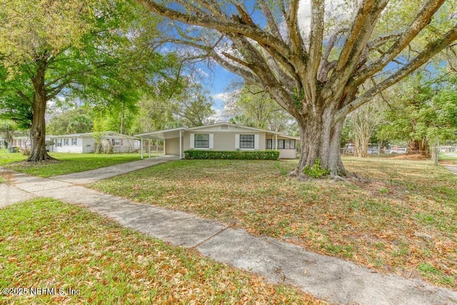 ranch-style home with a front yard and a carport