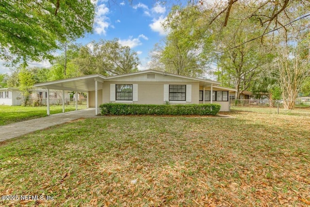 single story home featuring a front lawn and a carport