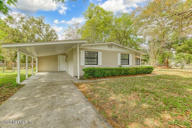 view of front of property featuring a front yard and a carport