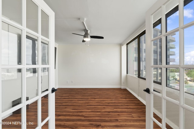 unfurnished sunroom featuring ceiling fan