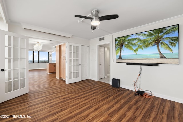 unfurnished room with ceiling fan with notable chandelier, dark hardwood / wood-style flooring, crown molding, and french doors