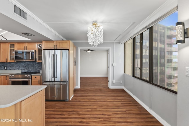 kitchen featuring decorative backsplash, appliances with stainless steel finishes, ornamental molding, dark wood-type flooring, and a notable chandelier