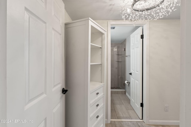 walk in closet with a chandelier