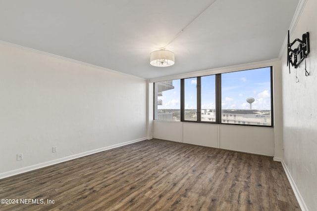 unfurnished room with dark hardwood / wood-style floors and crown molding