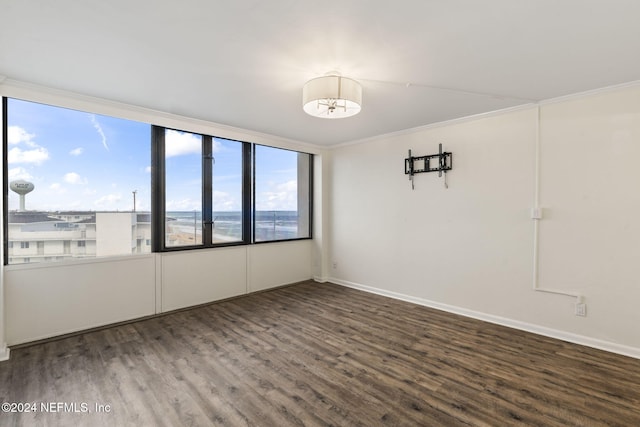 unfurnished room featuring ornamental molding and hardwood / wood-style flooring