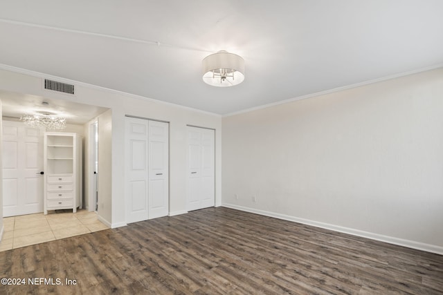 unfurnished bedroom featuring hardwood / wood-style floors and ornamental molding