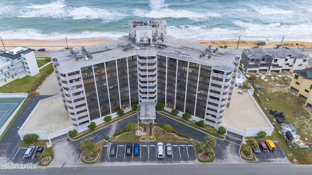 bird's eye view with a water view and a beach view