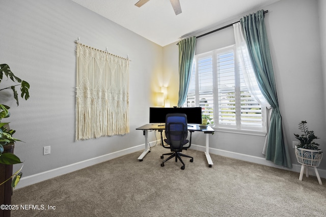 carpeted office space featuring ceiling fan and lofted ceiling