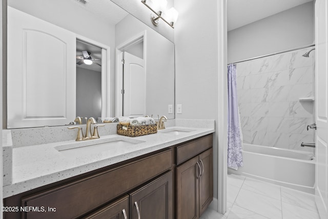 bathroom with ceiling fan, shower / bath combo with shower curtain, and vanity