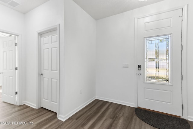 entrance foyer with dark hardwood / wood-style floors