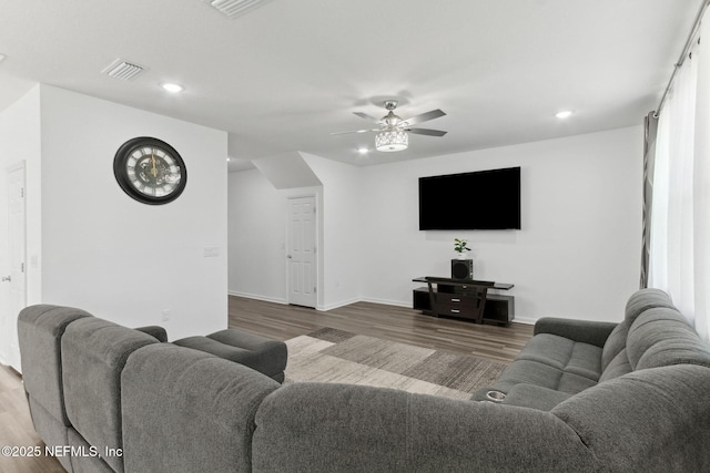 living room featuring hardwood / wood-style floors and ceiling fan