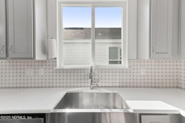 kitchen featuring decorative backsplash and sink