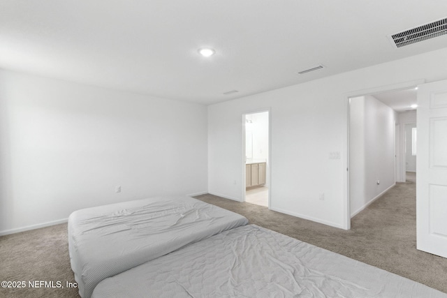 carpeted bedroom with connected bathroom