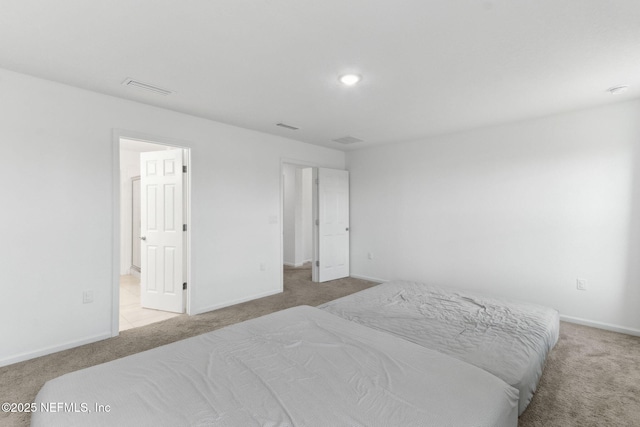 bedroom featuring light carpet