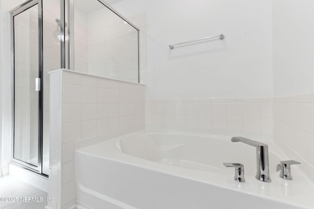 bathroom with separate shower and tub