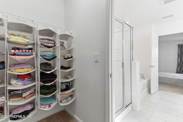 walk in closet featuring light tile patterned flooring