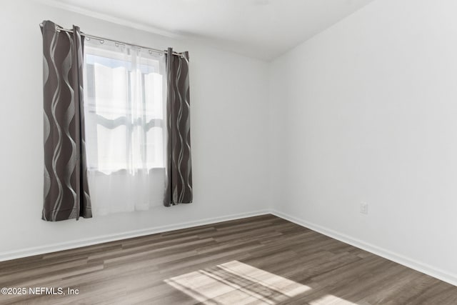 unfurnished room with dark wood-type flooring